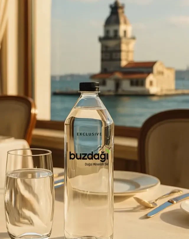 Restoran masasında şişede ve bardakta Buzdağı Serdivan, arka planda Kız Kulesi, “ideal su pH değeri” referanslı.